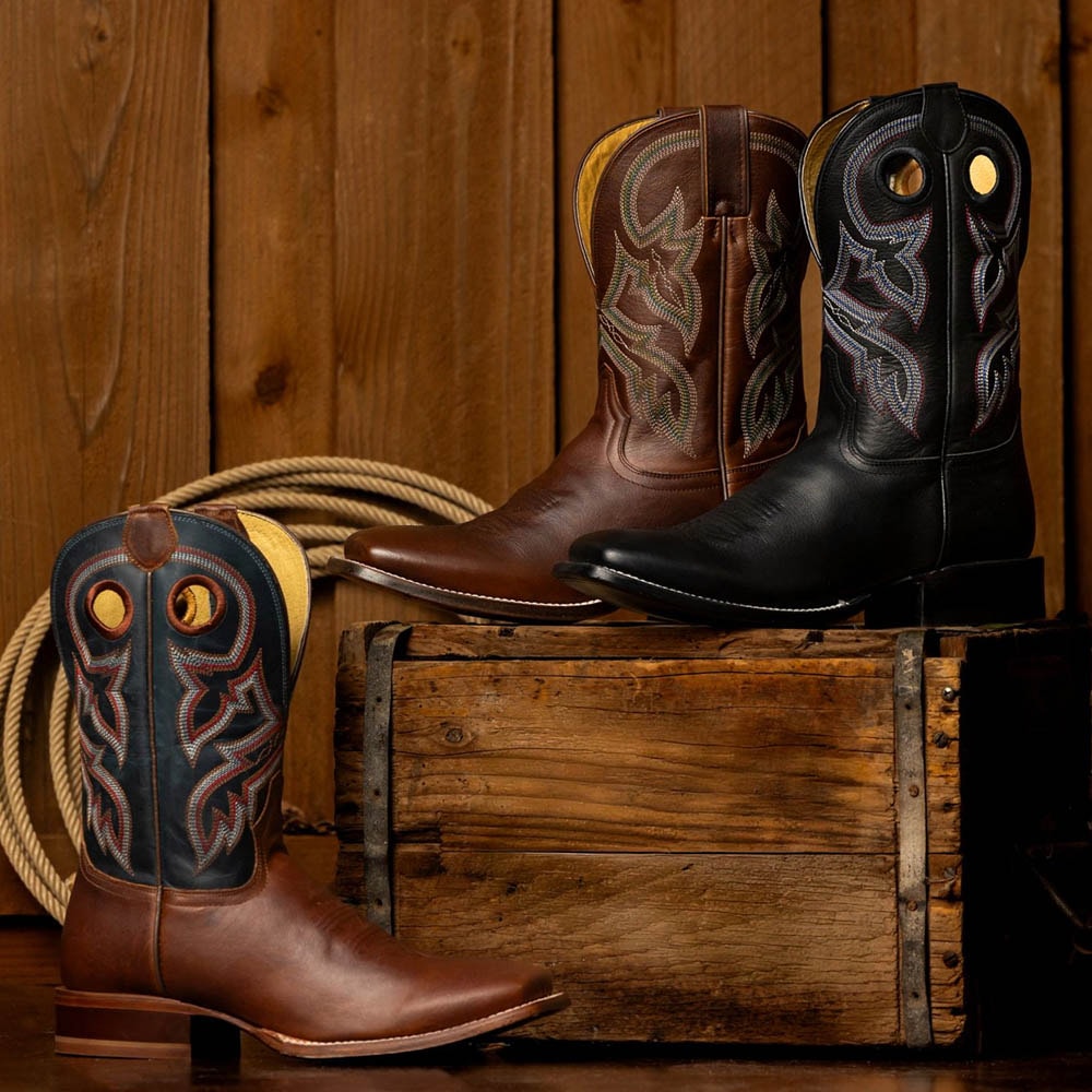 A lineup of the Men’s Ranchero collection in front of a wood wall.